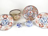 an image of a group of asian plates and bowls on a white surface