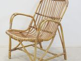 an image of a chair made out of bamboo with a white wall behind it