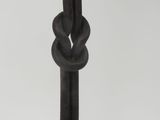 an image of a close up of a metal pole with a knot on it