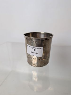 a close up of a silver cup on a glass table