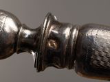 a close up of a silver object on a table