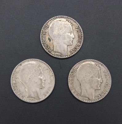 three silver coins with a profile of a man and a head of a woman