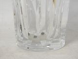 a glass vase that has a toothbrush inside of it