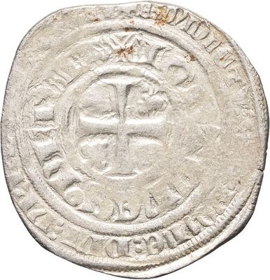 une vieille pièce d'argent ornée d'une croix
