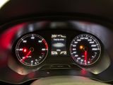 the dashboard of a car with two speedometers and a red light