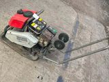 a small lawn mower that is laying on the ground