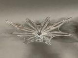 a glass snowflake that is sitting on a table