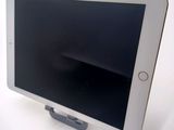 a tablet that is sitting on a stand on a table