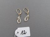 a pair of earrings and a tag on a table