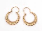 two pairs of gold hoop earrings on a white background