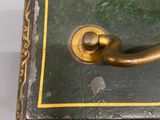 a green and gold box with a handle on it