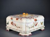 a white box with flowers and birds on it