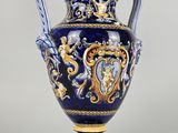 blue and gold vase with handles and handles on a gray background