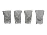 three shot glasses sitting next to each other on a white surface