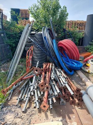 a pile of pipes and hoses on the ground