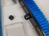 a blue brush and a bottle of water on a table