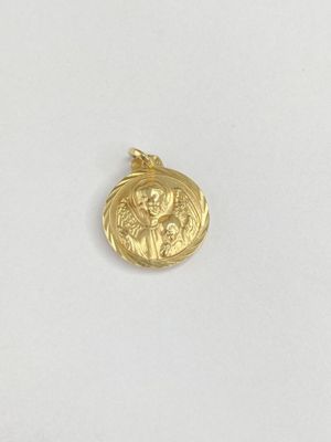a close up of a gold coin on a white surface