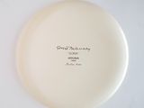 a white plate with writing on it sitting on a table