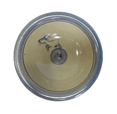 a brown bowl with a bird on it on a white surface