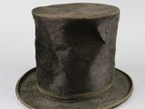 a black top hat on a white surface