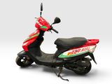 a red scooter with a green and red sticker on it