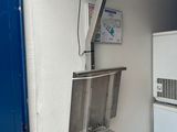 an image of a room with a scale and a refrigerator