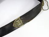 a black belt with a gold emblem on it