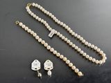 a close up of a necklace and earring on a table