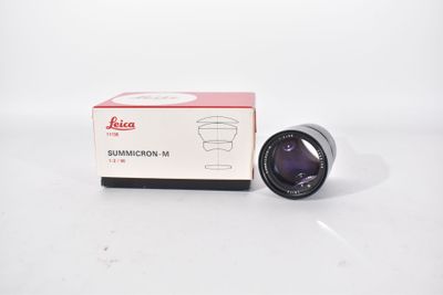 a close up of a camera lens on a white surface