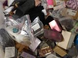 a white bag filled with assorted items on a bed
