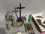 a lot of religious items that are sitting on a table
