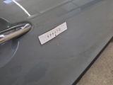a close up of a car door handle with a sticker on it