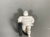 a small toy of a man with a wheel