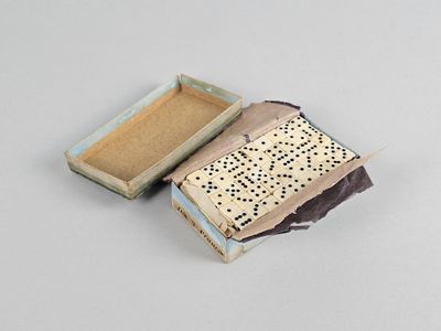 a small box that has a game of dominos inside of it
