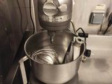 a mixer that is sitting on the counter in the kitchen