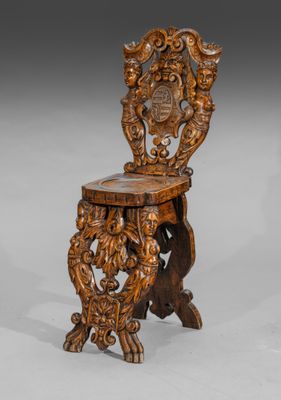 an old wooden chair with a carved back and seat