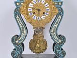 a blue and gold clock sitting on top of a table