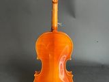 an orange violin sitting on top of a table next to a bow