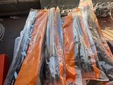 many bags of orange and black items sitting on a table