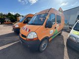 three vans parked in a parking lot next to each other