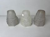 three salt and pepper shakers sitting on a table