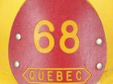 a yellow fire hydrant with a red and yellow number on it