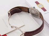 a watch sitting on top of a book on a table