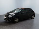 the small black car is parked in a large room