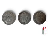 three different types of coins are shown on a white surface