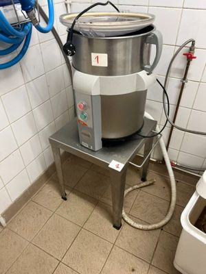 une photo d'une cuisine avec une grande marmite posée sur un trépied