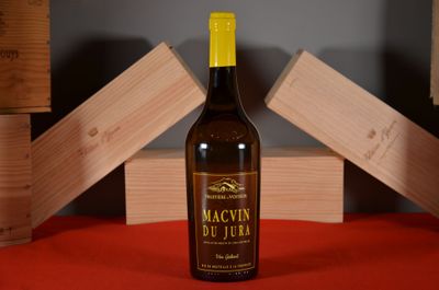 a bottle of wine sitting on a table next to a stack of wooden blocks