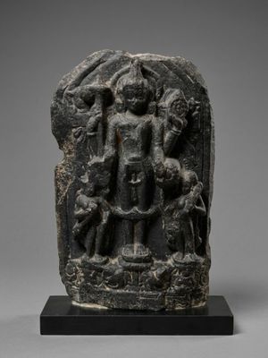a black stone statue of a man with a dog and a cat