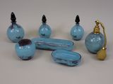five pieces of blue glass on a white table