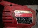a close up of a red electric drill with a red handle